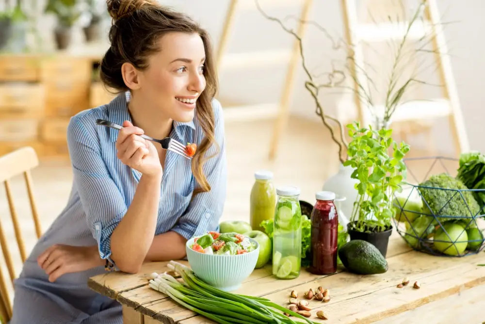 Young,And,Happy,Woman,Eating,Healthy,Salad,Sitting,On,The